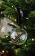 Close up of handblown glass Christmas bauble with green swirl pattern