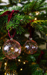 Close up of handblown glass Christmas bauble with red swirl pattern