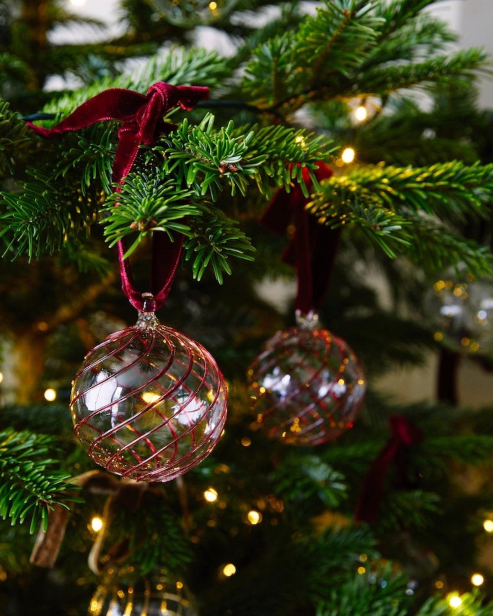 Close up of handblown glass Christmas bauble with red swirl pattern