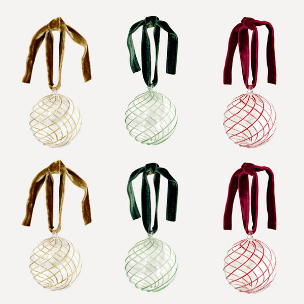 Set of six glass Christmas baubles with red green and gold swirl design